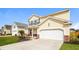 Two-story home with manicured lawn and a spacious driveway leading to an attached two-car garage at 4021 Sanderson Ln, Summerville, SC 29483