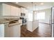 Bright kitchen with stainless steel appliances, an island, granite countertops and hardwood floors at 4021 Sanderson Ln, Summerville, SC 29483