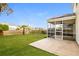 Backyard patio features an enclosed porch, concrete area, and grass yard with a wood fence surround at 4021 Sanderson Ln, Summerville, SC 29483