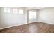 Bright room with hardwood flooring, modern paint, and natural light through large windows at 4021 Sanderson Ln, Summerville, SC 29483