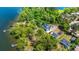 Serene aerial shot of a waterfront home nestled among trees, featuring a dock and stunning water views at 423 Lake Moultrie Dr, Bonneau, SC 29431