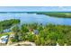 Stunning aerial view of lakeside home surrounded by lush trees and serene blue water at 423 Lake Moultrie Dr, Bonneau, SC 29431