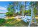 Scenic backyard featuring a swing, fire pit, and access to the waterfront at 423 Lake Moultrie Dr, Bonneau, SC 29431