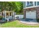 Backyard featuring a shed, white fence, and access to the garage with well-manicured landscaping and a serene setting at 423 Lake Moultrie Dr, Bonneau, SC 29431