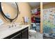 Cozy bathroom featuring a vanity, toilet, and shower with fish-themed curtain at 423 Lake Moultrie Dr, Bonneau, SC 29431