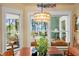 Inviting dining area featuring a pendant light and views of the waterway from multiple windows at 423 Lake Moultrie Dr, Bonneau, SC 29431