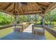 Picturesque view from the dock overlooking calm waters, a gazebo, and a waterfront home at 423 Lake Moultrie Dr, Bonneau, SC 29431
