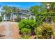 Charming home with lush landscaping, brick accents, and lake views, perfect curb appeal at 423 Lake Moultrie Dr, Bonneau, SC 29431