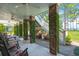 Inviting covered patio with brick pillars and verdant climbing plants offer a relaxing outdoor space at 423 Lake Moultrie Dr, Bonneau, SC 29431