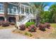 Front entrance stairs with garden bed, leading to a charming coastal style home at 423 Lake Moultrie Dr, Bonneau, SC 29431