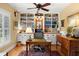 Bright home office with custom built-in shelves, desk, and rich hardwood floors at 423 Lake Moultrie Dr, Bonneau, SC 29431