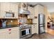 Modern kitchen with stainless steel appliances, custom cabinets, and stylish tile backsplash at 423 Lake Moultrie Dr, Bonneau, SC 29431