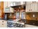 Gourmet kitchen features a stainless steel range, hood, and custom cabinetry at 423 Lake Moultrie Dr, Bonneau, SC 29431