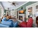 Comfortable living room with a fireplace, comfortable seating, and water views at 423 Lake Moultrie Dr, Bonneau, SC 29431