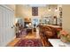 Inviting living room with hardwood floors, lake views, a fireplace, and access to the kitchen bar at 423 Lake Moultrie Dr, Bonneau, SC 29431