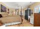 Main bedroom with a four-poster bed, ceiling fan, area rug, and warm lighting at 423 Lake Moultrie Dr, Bonneau, SC 29431