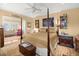 Spacious main bedroom with a four poster bed, ceiling fan, and doorway view to another room at 423 Lake Moultrie Dr, Bonneau, SC 29431