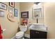 Charming powder room with decorative framed art, vessel sink on dark cabinets, and stylish fixtures, creating an inviting space at 423 Lake Moultrie Dr, Bonneau, SC 29431