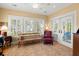 Bright sitting area with shutters, views of the waterway, and a wood bench seat at 423 Lake Moultrie Dr, Bonneau, SC 29431