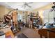Bright studio features easel, storage shelves, large windows, and ample workspace with natural light, ceiling fan, and neutral walls at 423 Lake Moultrie Dr, Bonneau, SC 29431