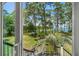 Scenic water view through the trees from the home's outdoor deck and yard at 423 Lake Moultrie Dr, Bonneau, SC 29431