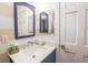 Bright bathroom featuring a clean white sink, custom vanity, and neutral striped walls that create a tranquil ambiance at 4233 Mariners Watch, Johns Island, SC 29455