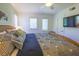 Well-lit bedroom with a comfortable bed, two windows, ceiling fan, and a television mounted on the wall at 4233 Mariners Watch, Johns Island, SC 29455