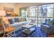 Comfortable living room with a plush white sofa, stylish rug, and a view to the sunroom, perfect for relaxing and entertaining at 4233 Mariners Watch, Johns Island, SC 29455