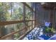 Relaxing screened porch with comfortable blue chairs and wooded views at 4233 Mariners Watch, Johns Island, SC 29455