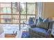 Cozy sunroom showcasing comfortable armchairs, views of the outdoors, and ample natural light through expansive glass doors at 4233 Mariners Watch, Johns Island, SC 29455