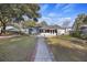 Charming home featuring a screened patio and backyard with stone walkway and ample green space at 4765 S Constellation Dr, North Charleston, SC 29418