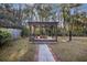 Backyard featuring a pergola with a fire pit, creating an inviting outdoor space at 4765 S Constellation Dr, North Charleston, SC 29418
