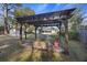 Backyard with a wood pergola, brick fire pit, and a walking path at 4765 S Constellation Dr, North Charleston, SC 29418