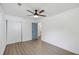 Light-filled bedroom with wood-look flooring, a ceiling fan, and a blue interior door at 4765 S Constellation Dr, North Charleston, SC 29418