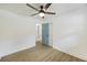 A bright bedroom features luxury vinyl plank flooring and a door to the remodeled bathroom at 4765 S Constellation Dr, North Charleston, SC 29418