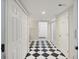 A hallway with a black and white checkered tile floor at 4765 S Constellation Dr, North Charleston, SC 29418
