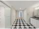 A hallway with a black and white checkered tile floor at 4765 S Constellation Dr, North Charleston, SC 29418