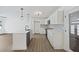 Modern kitchen with stainless steel appliances, white cabinetry, island, and stylish backsplash and lighting at 4765 S Constellation Dr, North Charleston, SC 29418