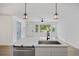 Bright, open kitchen featuring a modern island with a stainless steel dishwasher and pendant lights at 4765 S Constellation Dr, North Charleston, SC 29418