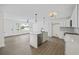 Open floor plan showcasing kitchen with island, stainless steel appliances, and a view to the living area at 4765 S Constellation Dr, North Charleston, SC 29418