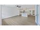 Open-concept living area with sleek flooring, a ceiling fan, and access to an elegant, all-white kitchen at 4765 S Constellation Dr, North Charleston, SC 29418