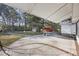 Expansive covered patio featuring brick accents, a concrete pad, and storage sheds in the fenced backyard at 4765 S Constellation Dr, North Charleston, SC 29418