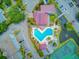 Aerial view of a community pool, tennis courts, and waterfront views surrounded by tropical landscaping at 5 Mariners Cay Dr, Folly Beach, SC 29439