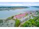 Wonderful aerial view highlighting waterfront condos with a marina, ample parking, lush landscaping, and access to the ocean at 5 Mariners Cay Dr, Folly Beach, SC 29439