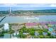 Aerial view of 5 Mariners Cay's waterways, marshland, tennis courts, and proximity to Center Street and the ocean at 5 Mariners Cay Dr, Folly Beach, SC 29439
