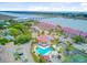Aerial view showcases the pool, landscaping, and waterways, highlighting the community's beautiful waterfront setting and amenities at 5 Mariners Cay Dr, Folly Beach, SC 29439