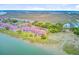 Aerial view of the complex and surroundings, showing the water, marsh and neighborhood at 5 Mariners Cay Dr, Folly Beach, SC 29439