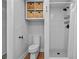 Clean bathroom featuring a toilet, shower with white tiling, and woven storage baskets for a minimalist and organized feel at 5 Mariners Cay Dr, Folly Beach, SC 29439