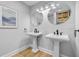 Elegant bathroom featuring double pedestal sinks, round mirrors, and modern fixtures, offering a stylish and functional space at 5 Mariners Cay Dr, Folly Beach, SC 29439
