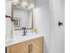 Stylish bathroom featuring a wood vanity, marble countertop, and modern fixtures, offering a sleek and functional design at 5 Mariners Cay Dr, Folly Beach, SC 29439